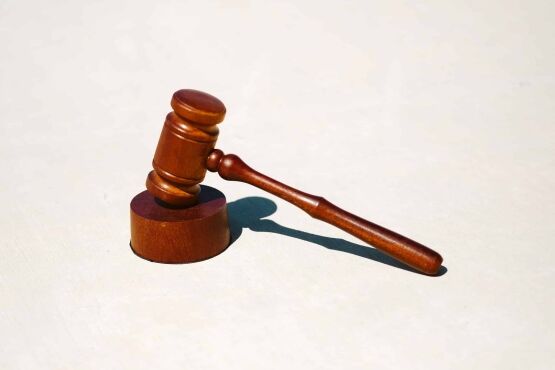 Judge's gavel resting on a white surface